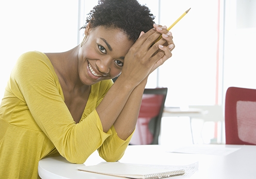A woman jots down a branch address for UAP Old Mutual Kenya on paper.