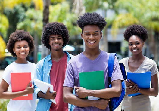 a group of youngsters walking with folders in their hands