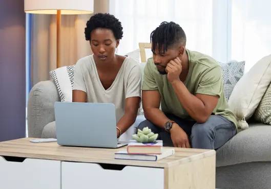 couple on laptop in home