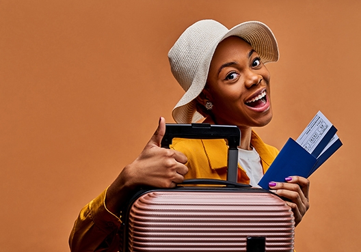 young lady with her luggage and passport looking at the camera