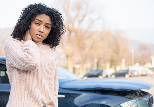 young woman standing next to a car