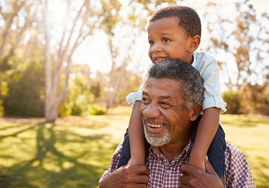 son sitting on dad's shoulders