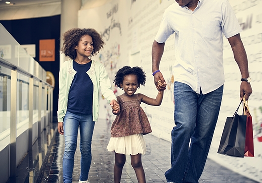 father walking with his two daughters