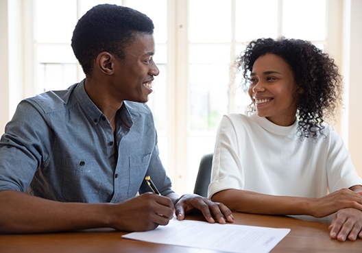 Two people are talking to one another at a table