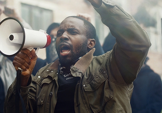 woman looking out of the window with a worried look on her face