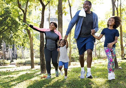 family walking in the forest hand in hand