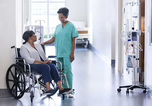 doctor talking to a woman in a wheelchair