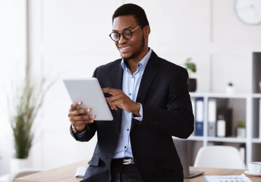 young businessman in suit using digital tablet in office