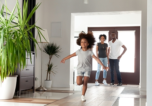 daughter running into the house with her parents watching by the door