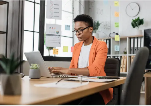 woman sitting at office and using wireless laptop