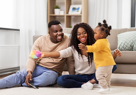 A family covered by Afyaimara Family County insurance are sitting on the floor 